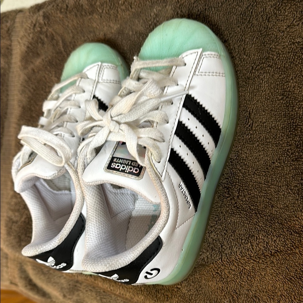 Adidas White and Black Sneakers with Iconic Stripes